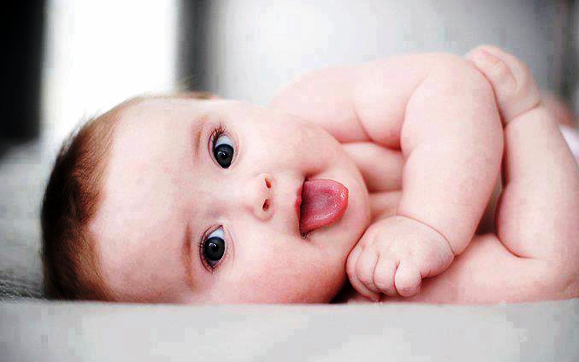 cute boy baby showing tounge