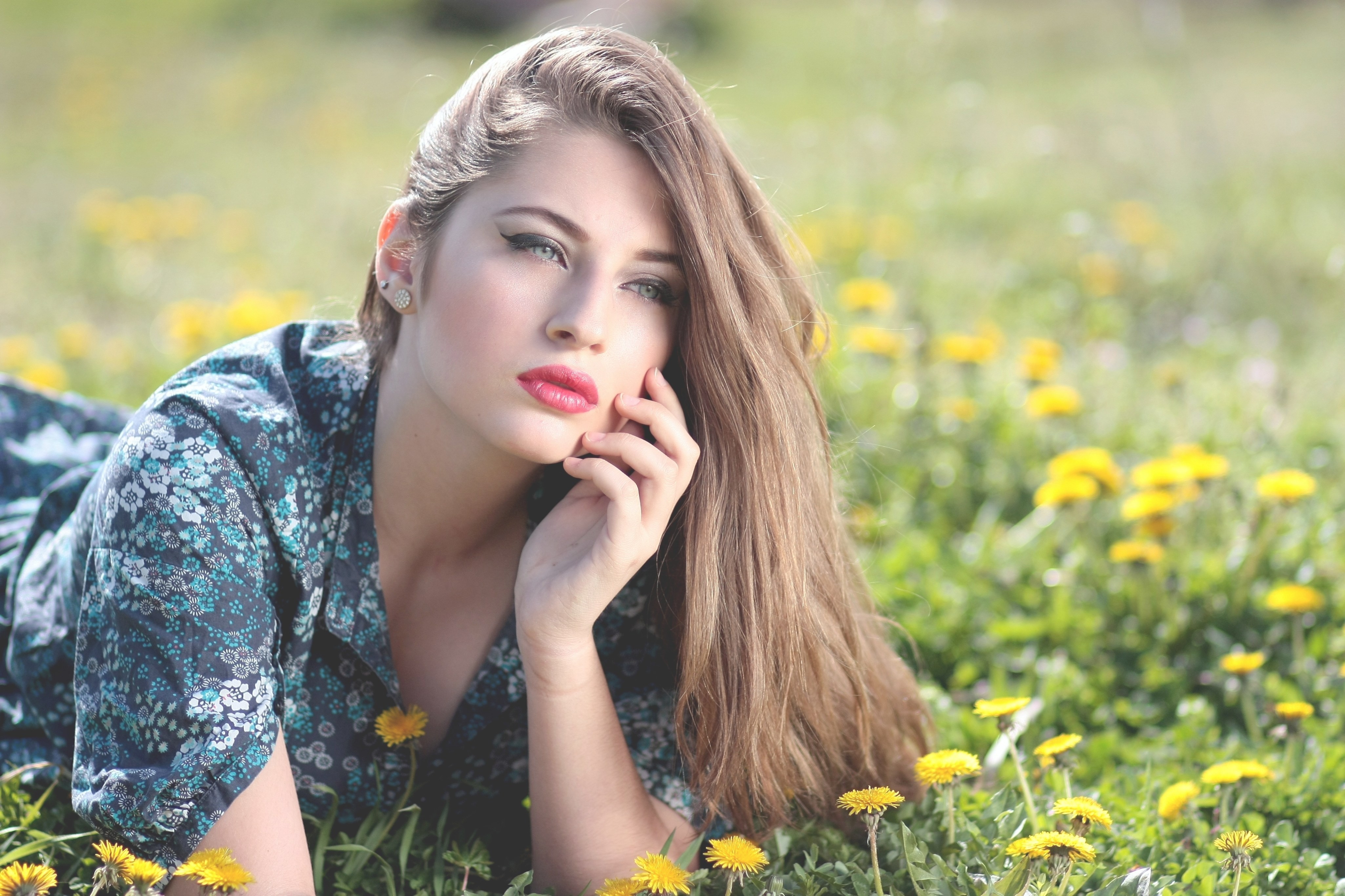 cute girl lying on yellow flower field during daytime