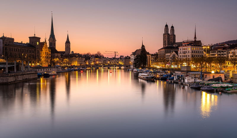 zurich cityscape limmat river sunset old town switzerland lights reflection
