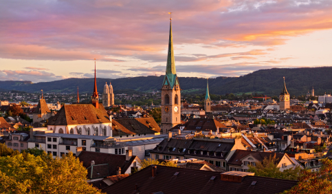 zurich cityscape sunset church spires grossmunster fraumunster old town rooftops switzerland