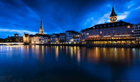 zurich limmat river night blue hour church spires city lights reflection